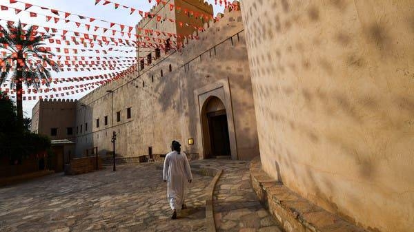 A man walking past the walls of the Nizwa Fort in Oman. -- File photo
