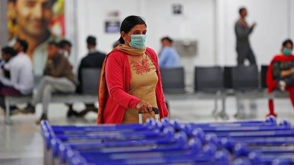 A passenger wearing a protective mask walks inside an airport terminal in New Delhi. -- Courtesy photo
