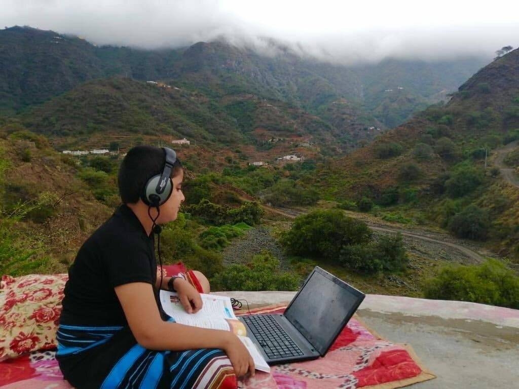 A photo shared on Twitter shows a boy distance learning via a laptop in Tihamah, Saudi Arabia.