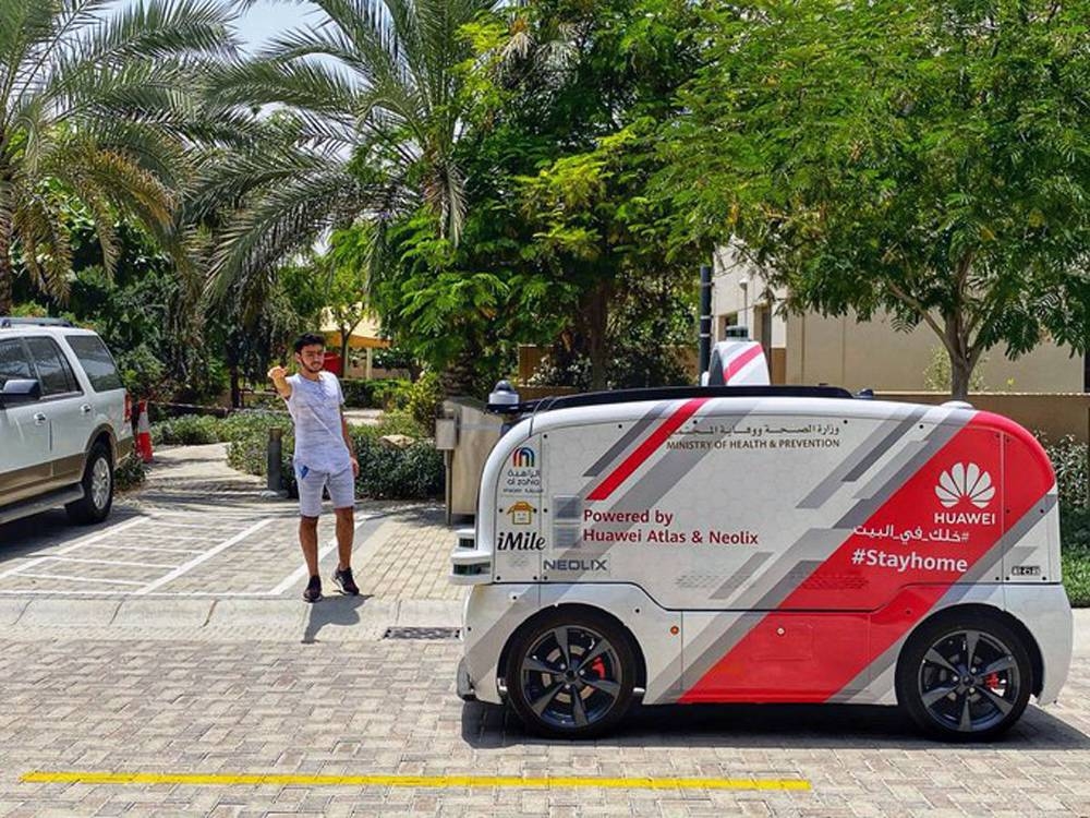 A self-driving vehicle distributes personal protective equipment including masks, gloves and sanitizers to residents and workers of a residential complex in Sharjah.