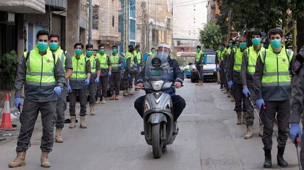 Volunteers from Hezbollah's Islamic Health Association line the streets during a Hezbollah-organized media tour in Beirut. — Courtesy photo