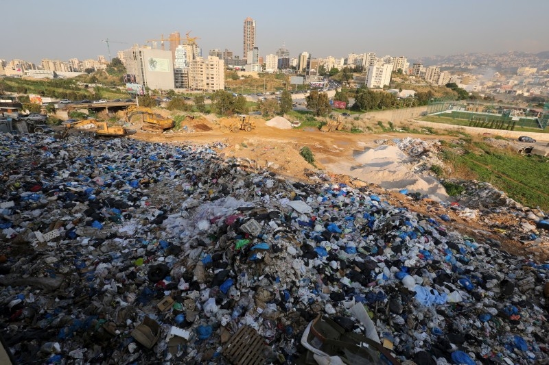 A protester, wearing a garbage bag and holding up a sign, takes part in a protest against what demonstrators say is the government's failure to resolve a crisis over rubbish disposal in Beirut, Lebanon March 12, 2016.


