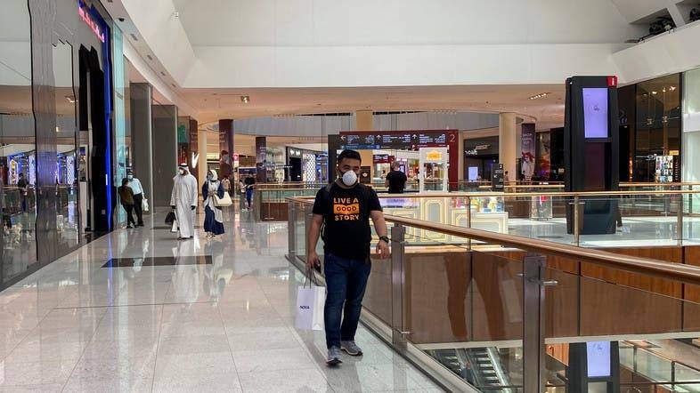 People wearing protective face masks shop at Dubai mall after the UAE government eased a curfew and allowed stores to open. -- File photo
