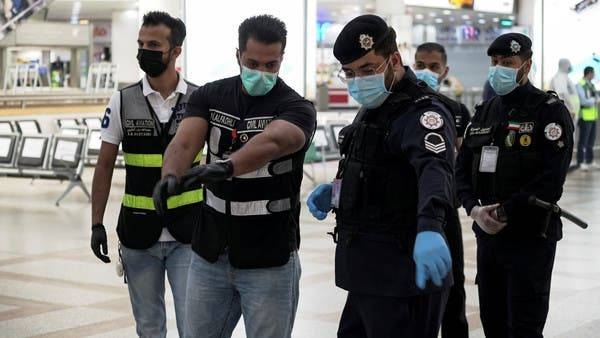Police and civil aviation personnel wearing protective face masks work at Kuwait Airport as the repatriation process of Kuwait citizens continues. -- Courtesy photo