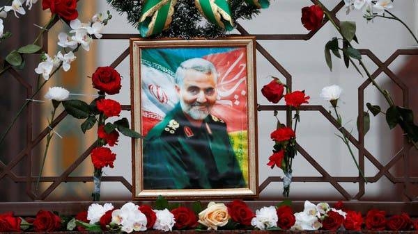 A supporter of the Houthis in Yemen has a poster attached to his waist of Soleimani. 