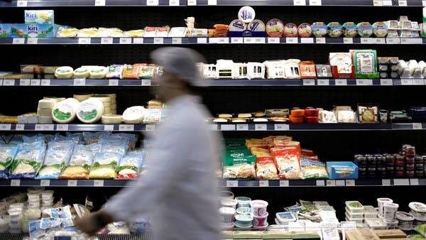 A worker walks past food items displayed for sale inside a supermarket in Beirut. -- Courtesy photo
