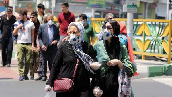 Iranian women wearing protective masks cross a street in the capital Tehran. -- File photo 