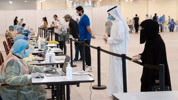 Kuwaitis give their details to ministry of health officials in a makeshift coronavirus testing center. -- File photo
