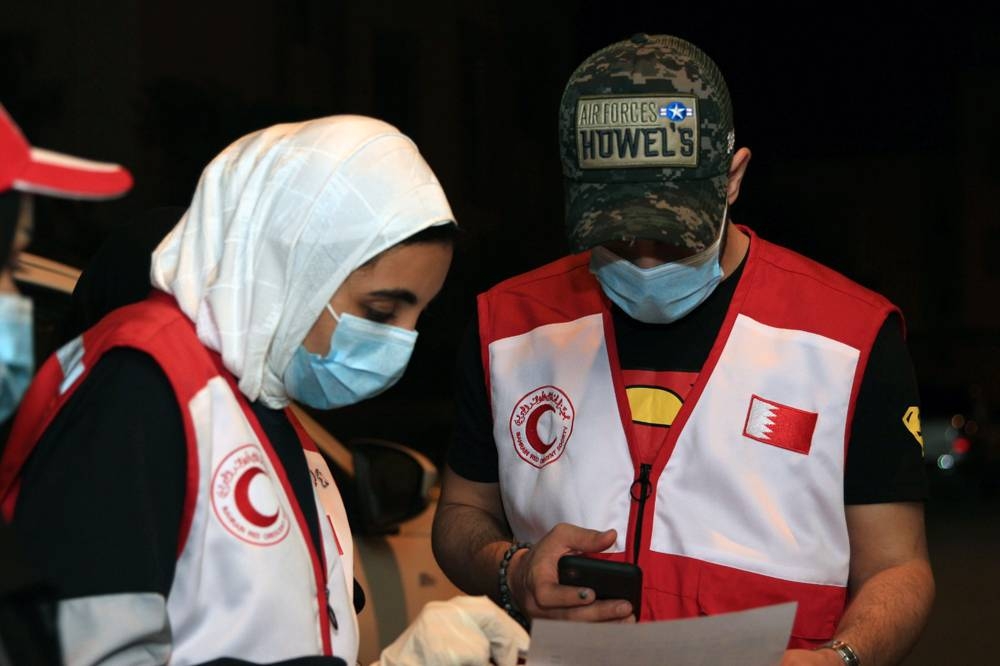 Bahrain Red Crescent Society  volunteers delivering aid to needy families.