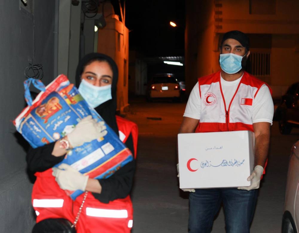 Bahrain Red Crescent Society  volunteers delivering aid to needy families.