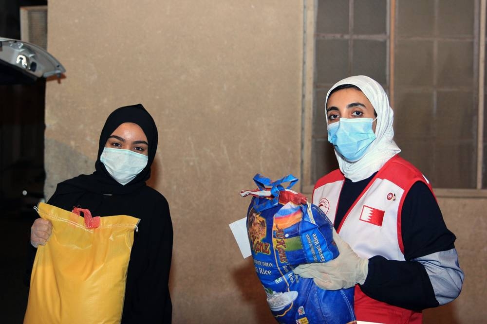 Bahrain Red Crescent Society  volunteers delivering aid to needy families.