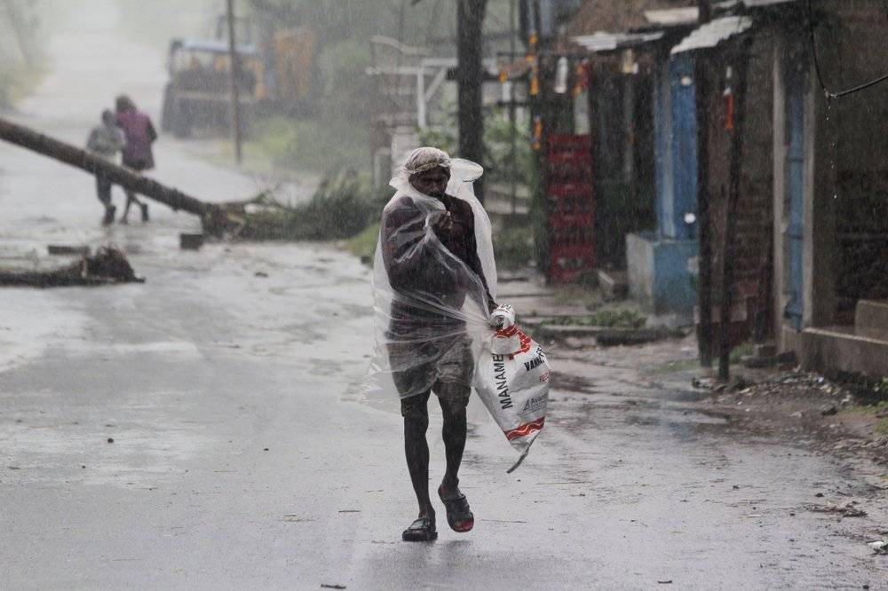A man covers himself with a plastic sheet and walks in the rain ahead of Cyclone Amphan landfall, at Bhadrak district, in the eastern Indian state of Odisha, on Wednesday. — Courtesy photo