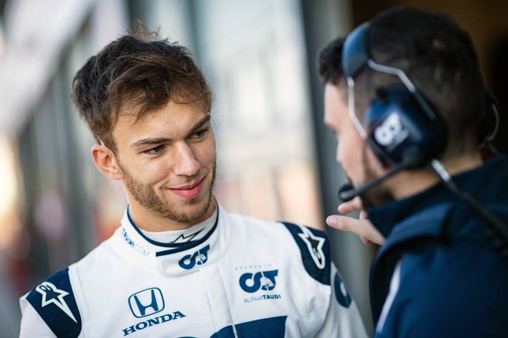 Pierre Gasly of France and Scuderia AlphaTauri talks to his mechanic during the filming day in Misano, Italy on Feb. 15, 2020.