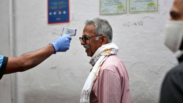 A staff member checks a man's body temperature before allowing him into an eatery in the southern Indian city of Bengaluru. -- Courtesy photo
