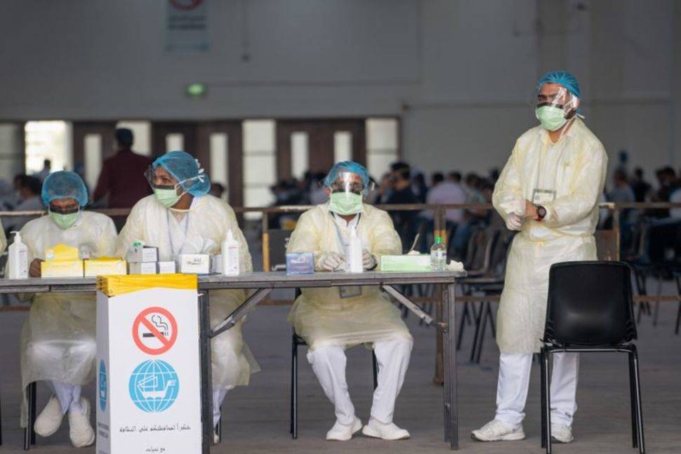 Nurses await to admit people in a makeshift coronavirus testing center at the Mishref Fair Grounds in Kuwait City in this file photo. 
