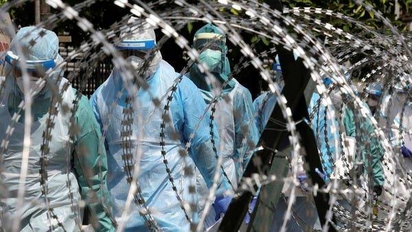 Medical workers wearing protective suits pass by barbed wire at the red zone under enhanced lockdown, amid the coronavirus outbreak in Petaling Jaya, Malaysia in this file photo. — Courtesy photo