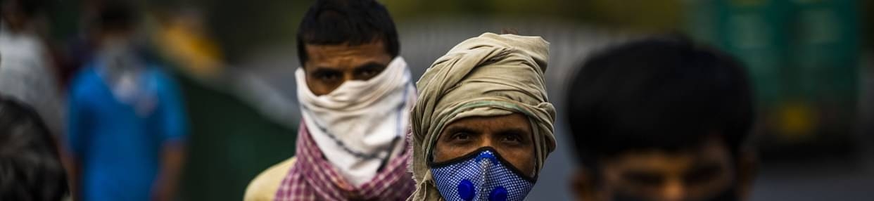 People wearing protective masks walk along a sidewalk during a partial lockdown imposed due to the coronavirus in New Delhi, India. — Courtesy photo
