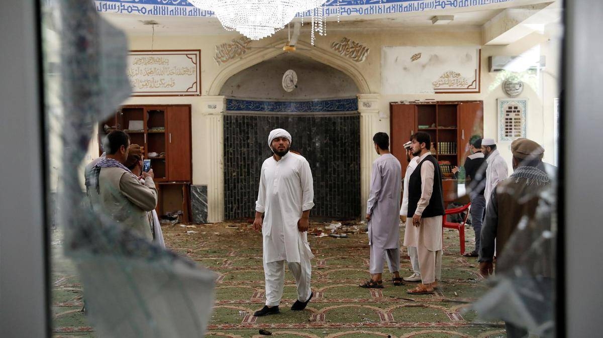 Men inspect the site of a blast inside a mosque in Kabul, Friday. — Courtesy photo
