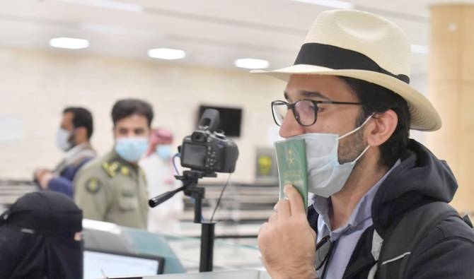 An overwhelmed Saudi coming from New York kisses his passport on arrival in Riyadh. — SPA

