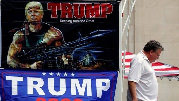 A man walks past banners of US President Donald Trump sits on a roadblock near the BOK Center for his upcoming rally in Tulsa. — Courtesy photo
