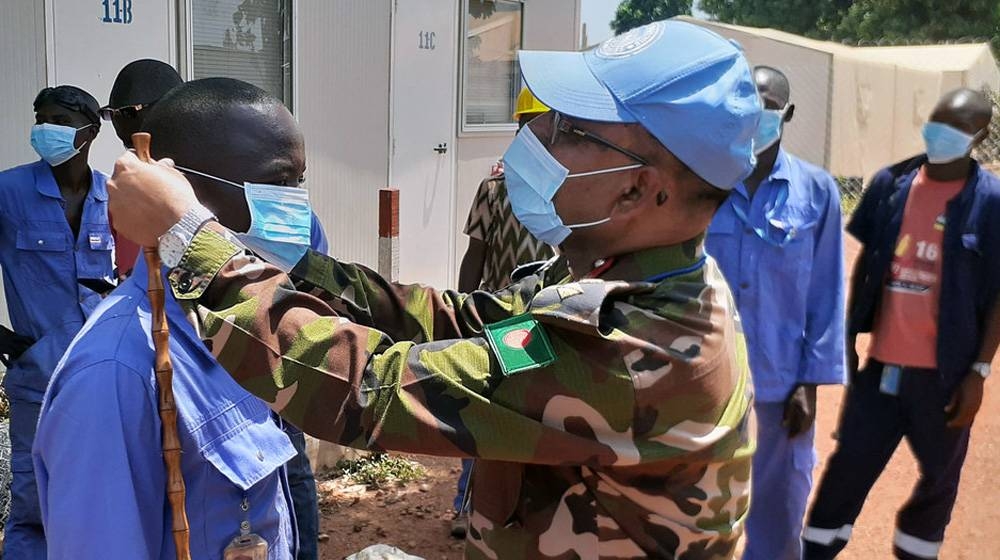 As part of the information campaign on COVID-19, the commander of the Bangladeshi medical contingent at the UN peacekeeping mission in the Central African Republic, encourages local contractors to wear protection masks. — courtesy MINUSCA