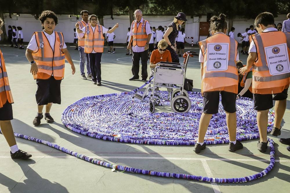 BISJ has created the world’s longest chain of bottle caps by threading 323,103 bottle caps together.