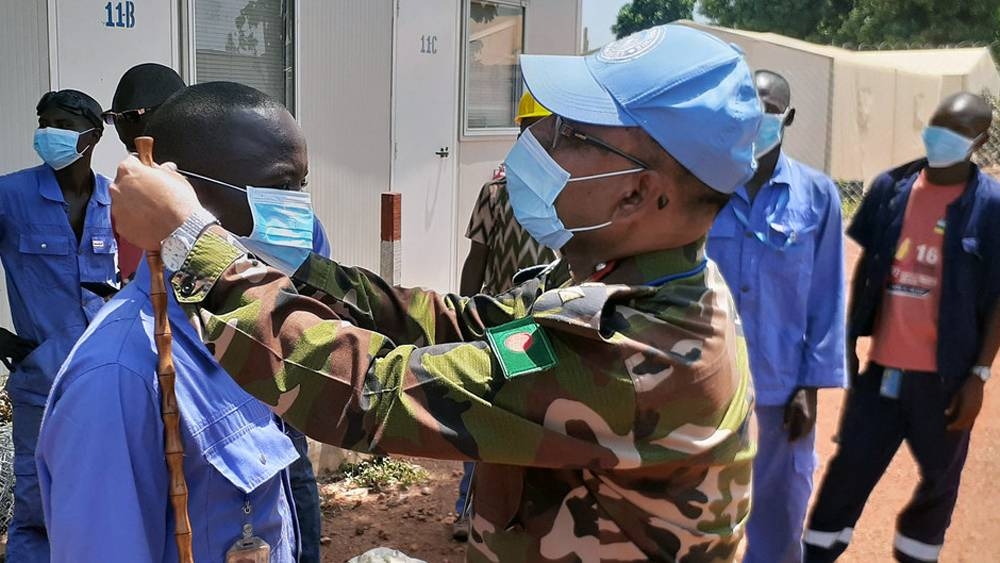 

As part of the information campaign on COVID-19, the commander of the Bangladeshi medical contingent at the Security Council-mandated UN peacekeeping mission in the Central African Republic, encourages local contractors to wear protection masks. — courtesy MINUSCA