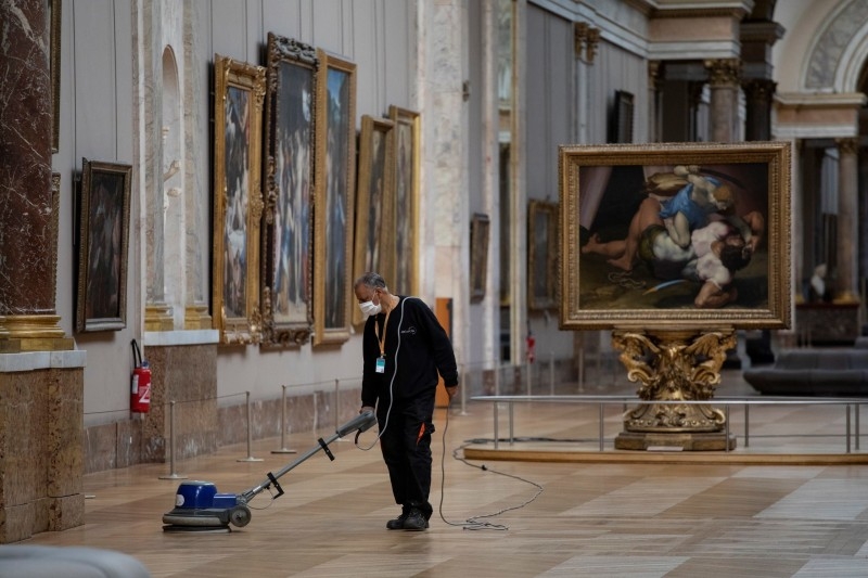 An employee cleaning the floor of a room of the Musee du Louvre in Paris. — Courtesy photo
