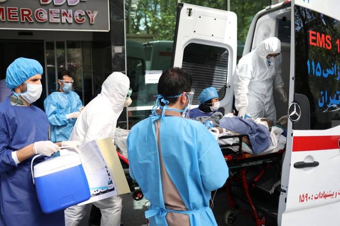 Emergency medical staff and nurses transfer a patient with coronavirus to Masih Daneshvari Hospital in Tehran in this file photo.
