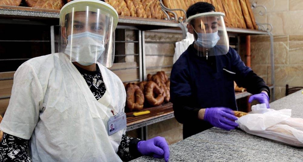Vendors in a bakery in Constantine, Algeria, during the COVID-19 crisis. — courtesy ILO/Yacine Imadalou