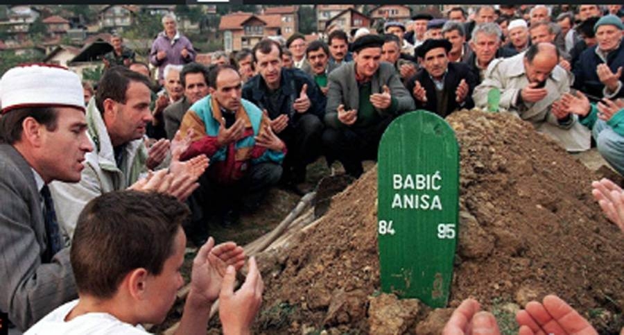 File photo of Bosnians at a grave of a Srebrenica genocide victim.