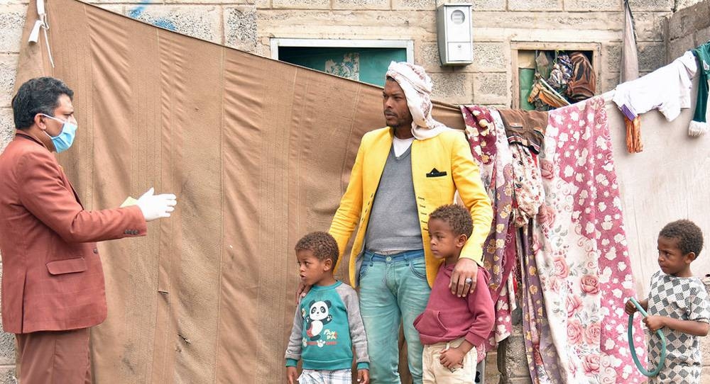 Volunteers teach people living in settlements, in Sanaa, Yemen, instructing them on social distancing and other preventative measure against COVID-19. — courtesy UNICEF