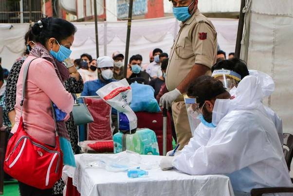 Medics conduct a health check-up for passengers at Jammu railway station following the resumption of passenger train services. — File photo
