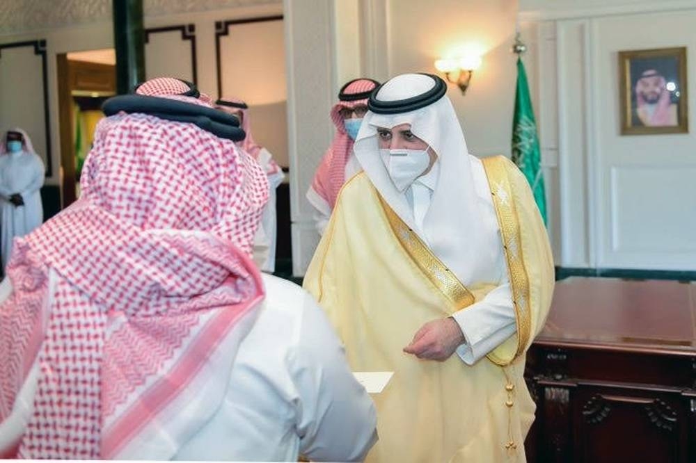 Emir of Tabuk Prince Fahd Bin Sultan distributes financial compensation to owners of properties in the NEOM project region at his office in Tabuk on Sunday.