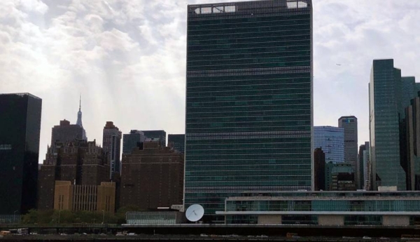 UN headquarters against sun rays beaming from cloudy skies. — courtesy UN News/Anton Uspensky