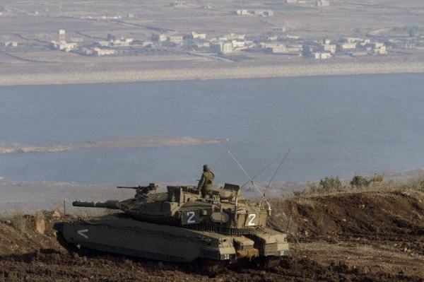 An Israeli tank in the Golan Heights overlooks the Syrian village of Bariqa last November. — File photo

