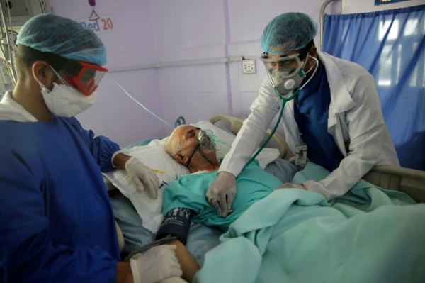 Medical workers attend to a COVID-19 patient in an intensive care unit at a hospital in Sanaa. — File photo
