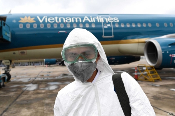 A worker wearing a protective suit prepares to disinfect a Vietnam Airlines plane amid concerns of the spread of the COVID-19 coronavirus at Noi Bai International Airport in Hanoi in this March 3, 2020 file picture. — Courtesy photo