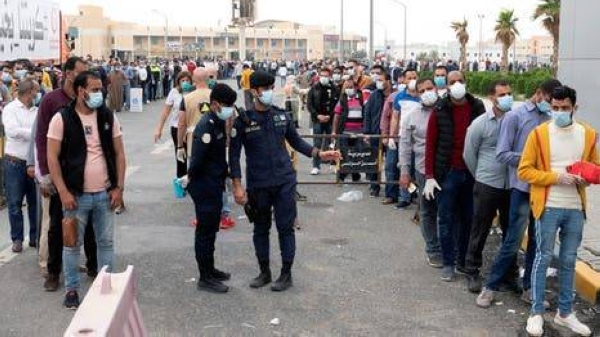 Expatriates wait for mandatory coronavirus testing in a makeshift testing center in Mishref, Kuwait, in this file picture. — Courtesy photo