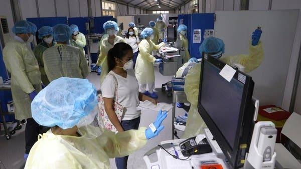 A woman waits to be tested by medical staff wearing protective equipment at a hospital in Abu Dhabi in this file picture. — Courtesy photo