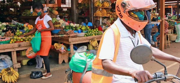 A SafeBoda rider and market vendor use the SafeBoda app to deliver food and supplies during the COVID-19 lockdown in Kampala, Uganda. — courtesy UNCDF
