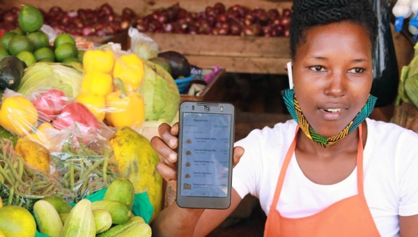 A SafeBoda rider and market vendor use the SafeBoda app to deliver food and supplies during the COVID-19 lockdown in Kampala, Uganda. — courtesy UNCDF
