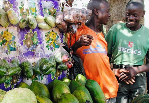 A SafeBoda rider and market vendor use the SafeBoda app to deliver food and supplies during the COVID-19 lockdown in Kampala, Uganda. — courtesy UNCDF
