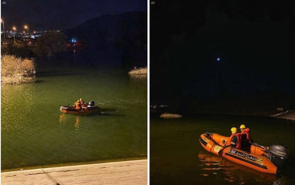 Rescuers from the Civil Defense are seen on an inflatable rubber boat in Taif's Wadi Saab dam on Saturday night. — SPA
