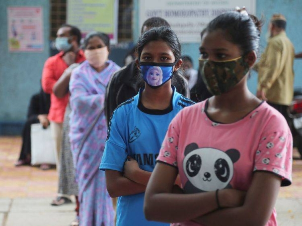 People wait in a queue to give their nasal swab samples to test for COVID-19 in the southern city of Hyderabad, Sunday. — Courtesy photo
