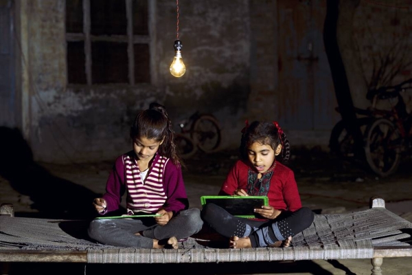 Two little Indian girls studying in single light bulb in the dark. Expo 2020 Dubai has joined forces with the Bill & Melinda Gates Foundation to support grassroots innovators with the ambition and potential to improve the lives of people across a variety of complex, fragile or marginalized humanitarian settings,