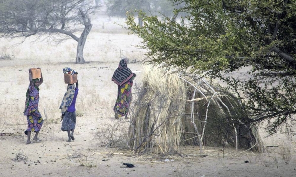 

File photo shows women walking at a camp sheltering internally displaced persons in Mellia, Lac region, in western Chad. — courtesy OCHA/Ivo Brandau