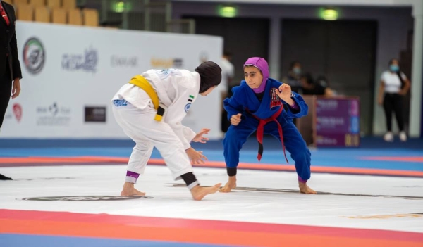 Noura Al Kaabi, minister of culture and youth, and Mohammed Salem Al Dhaheri, vice president of the UAE Jiu-Jitsu Federation awarding the winners.