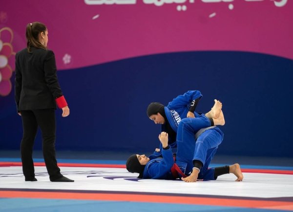 Noura Al Kaabi, minister of culture and youth, and Mohammed Salem Al Dhaheri, vice president of the UAE Jiu-Jitsu Federation awarding the winners.