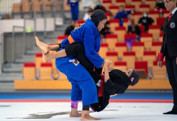 Noura Al Kaabi, minister of culture and youth, and Mohammed Salem Al Dhaheri, vice president of the UAE Jiu-Jitsu Federation awarding the winners.